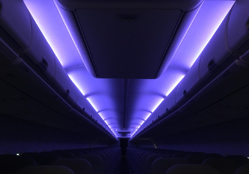 Cobalt Spectrum LED mood lighting illuminating an aircraft cabin with purple light.